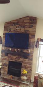 TV mounted on stone fireplace